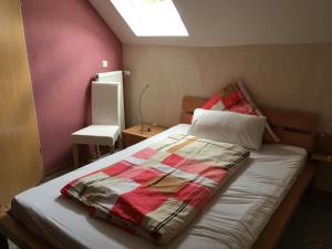 a bedroom with a bed with a colorful blanket on it at Fährmannshaus in Ernst