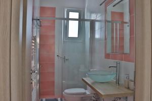 a bathroom with a bowl sink and a toilet at ARIA Luxury Apartments in Nafplio +44 photos
