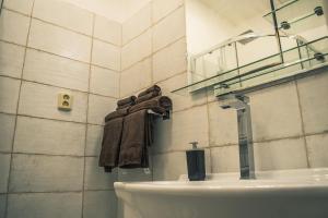 a bathroom with a toilet and a sink and a towel at Apartman JnJ Velkomoravska in Olomouc