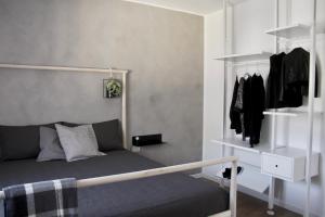 a bedroom with a bed and a rack of clothes at Fortuna's quiet place in Riva del Garda