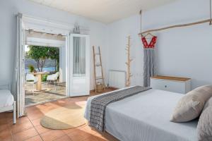 A bed or beds in a room at Ornos Blue