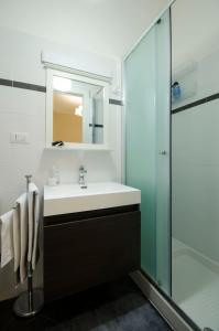 a bathroom with a sink and a shower at Saint Philippe Maison in Aci Catena