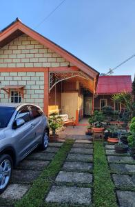 a car parked in front of a house at Villa Daffa Ciwidey in Ciwidey