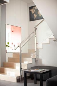 a staircase with a table and a glass railing at Hotel Mercedes in Camargo