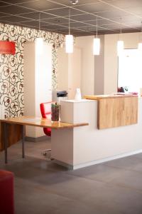 an office with a desk and a red chair at Hotel Mercedes in Camargo