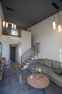a living room with a couch and a table at Tramonto Suites in Xi