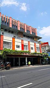 a large building with a hotel on the side of a street at Mitra Hotel in Yogyakarta