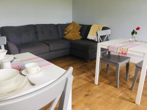 a living room with a couch and a table and chairs at Ferney House in Irvinestown