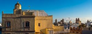 a building with a clock tower on top of it at Hotel de Francia y París in Cádiz