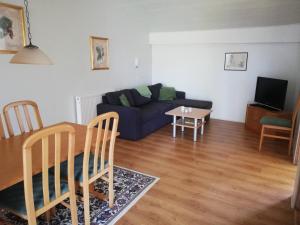 a living room with a couch and a table at Bindesbølgård Farm Holiday in Give