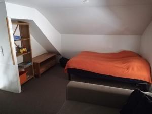 a small bedroom with a bed and a couch at Bindesbølgård Farm Holiday in Give