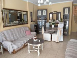 a living room with a couch and a table at Anthi Apartment in Paleo Tsifliki