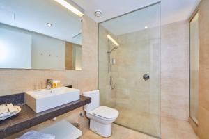 a bathroom with a toilet a sink and a bathtub at Santa Clara Urban Hotel & Spa in Palma de Mallorca