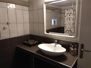 a bathroom with a sink and a mirror at Anthi Apartment in Paleo Tsifliki +45 photos