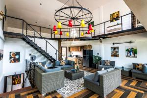 a living room with couches and a staircase at Victory Road Villas in Phong Nha