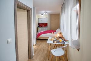 a small room with a bed and a table with a book at Rent House Karavi in Iraklitsa