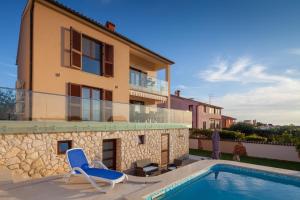 a villa with a swimming pool and a house at Villa Nicole in Banjole