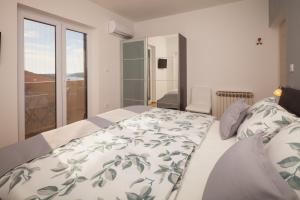 a bedroom with a large bed and a balcony at Villa Nicole in Banjole +49 photos