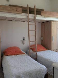 a bedroom with two bunk beds and a ladder at Casa da Serra in Azeitao