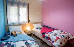 a bedroom with two beds next to a window at Rent House Karavi in Iraklitsa