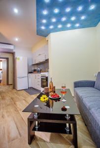 a living room with a couch and a table with wine glasses at Rent House Karavi in Iraklitsa
