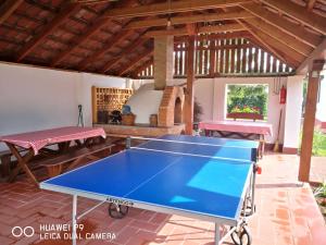 a ping pong table in the middle of a patio at Szenkeparti Vendégház in Penyige