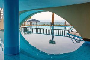 a swimming pool with a reflection of the ocean at Rent House Karavi in Iraklitsa