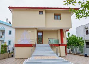 a house with stairs leading up to it at Rent House Karavi in Iraklitsa