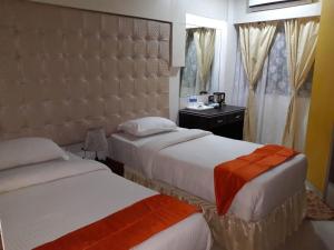 Postel nebo postele na pokoji v ubytování Setrac Orange Hotel