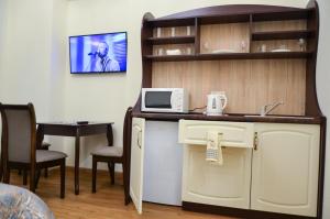 a room with a kitchen with a sink and a microwave at Apartment nr. 8 in Odesa