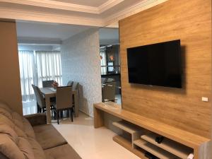 a living room with a flat screen tv on a wall at Apartamento 602 Edifício Thermas Palace in Piratuba