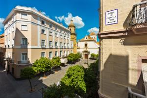a view of a city with buildings and a clock tower at Hotel de Francia y París in Cádiz