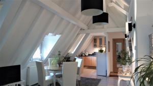 a kitchen and dining room with a table and refrigerator at Victor et Léontine in Ribeauvillé +11 photos