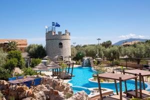 a pool at a resort with a tower at Villa Elia Resort in Lefkada Town