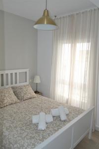 a bedroom with a large bed with two pillows on it at Guimar Advance en plena judería in Córdoba