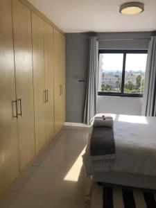 a bedroom with a large bed and a window at Home relaxation in the city in Cape Town +12 photos