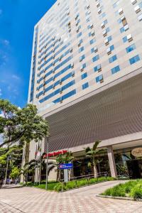 a tall building with a clock on the front of it at Hilton Garden Inn Belo Horizonte Lourdes in Belo Horizonte