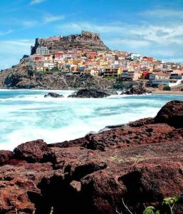 a city on top of a hill next to the ocean at L'Antico Faro in Castelsardo