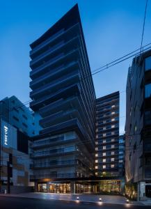 a large office building with a lot of windows at Bespoke Hotel Shinsaibashi in Osaka