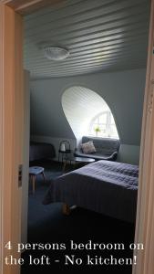 a room with a bed and a room with a window at Aagaarden in Billund