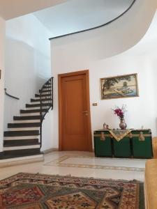 a living room with a staircase and a door at Casa delle Aci in Acireale