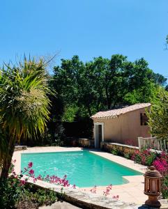 a swimming pool in a yard next to a house at La Farigoule in Aix-en-Provence