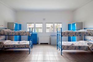 a bed room with two beds and a window at Ostello Corniglia in Corniglia