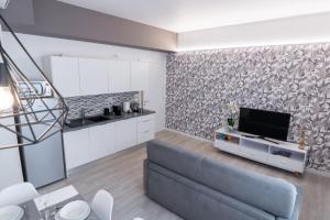 a living room with a couch and a tv at Dolce Notte Apartments in Verona