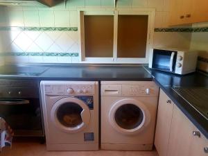 a kitchen with a washer and dryer in a kitchen at Hostal Brunete in Brunete