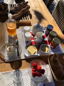 een dienblad met aardbeien en een drankje op een tafel bij Villa Chamarel in Carcès