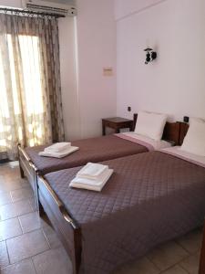 a bedroom with two beds with towels on them at Katerina Apartments in Stalís