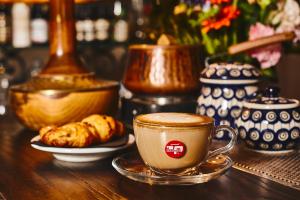 a cup of coffee and a plate of food on a table at IL VIAGGIATORE VIA PIAVE in Gaeta