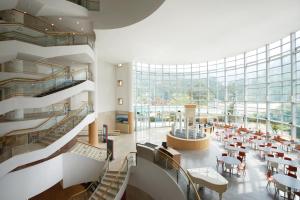 a view of the lobby of a building with tables and chairs at Hanwha Resort Sanjeong Lake Annecy in Pocheon