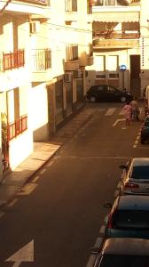 an empty street in a building with cars parked at Paraiso Huertano in Alquerías